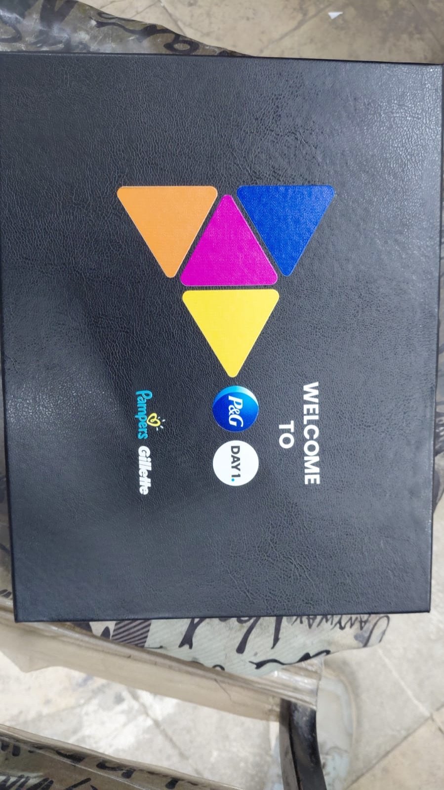 Black welcome box printed with Welcome to P&G Day 1 and brand logos